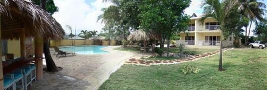 Property Photo: bar, pool, garden + condo bldg